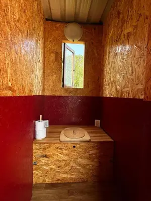 a bathroom with a sink and a window at Michas caravan for 2 See the herd of horses from your bed in Barão de São João