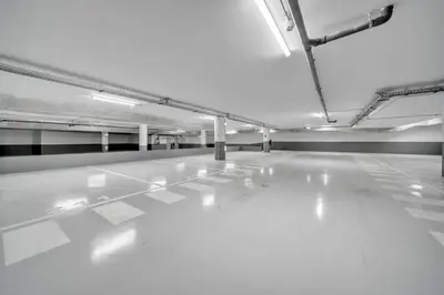 an empty room with a white floor and lights at In-Town Residences in Funchal