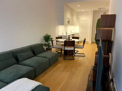 a living room with a green couch and a table at In-Town Residences in Funchal