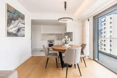 a kitchen and dining room with a table and chairs at Acqua Residence in Funchal