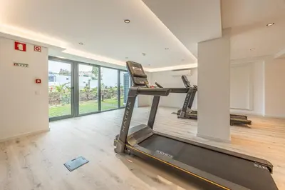 a room with a gym with two treadmills at Acqua Residence in Funchal