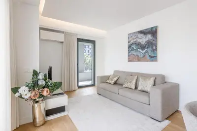 a living room with a couch and a tv at Acqua Residence in Funchal