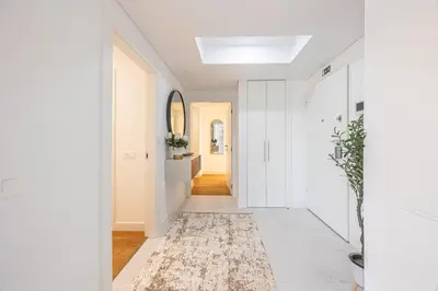 a hallway with white walls and a ceiling with a skylight at Acqua Residence in Funchal