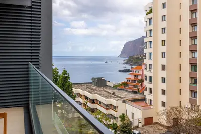 a view of the ocean from the balcony of a building at Acqua Residence in Funchal