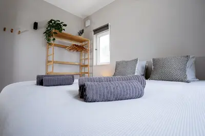 a bedroom with a large white bed with three pillows at Orteá Sea Breeze in Budens