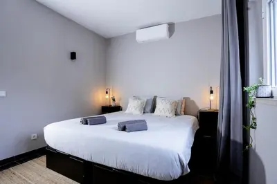 a bedroom with a large white bed with two pillows at Orteá Sea Breeze in Budens