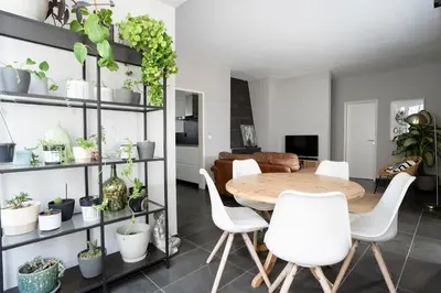 a dining room with a table and white chairs at Orteá Sea Breeze in Budens