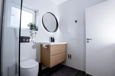 a bathroom with a toilet and a sink and a mirror at Orteá Sea Breeze in Budens