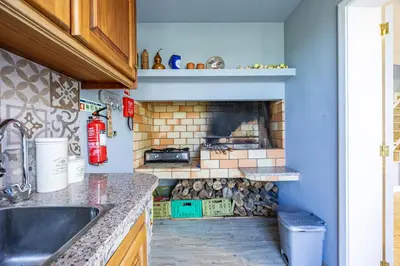 a kitchen with a brick oven in the wall at Casa da Fonte by YOUR KEY - 1st floor house in Ribeira Brava