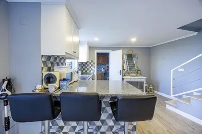 a kitchen with a counter and some blue walls at Casa da Fonte by YOUR KEY - 1st floor house in Ribeira Brava
