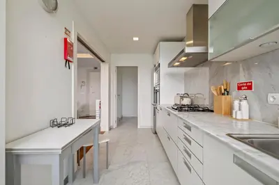 a kitchen with white cabinets and a counter top at SeaSide Serenity II in Funchal