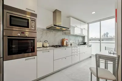 a kitchen with white cabinets and stainless steel appliances at SeaSide Serenity II in Funchal