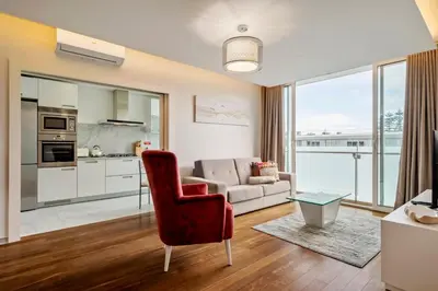 a living room with a red chair and a couch at SeaSide Serenity II in Funchal