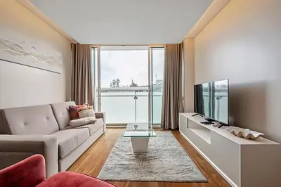 a living room with a couch and a tv at SeaSide Serenity II in Funchal