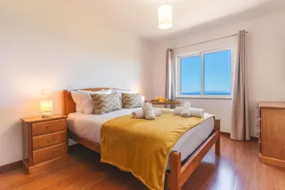 a bedroom with a bed with two stuffed animals on it at My Home Reis Magos by Atlantic Holiday in Caniço