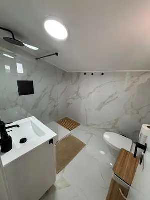 a white bathroom with a sink and a toilet at Villas Sossego in Porto Santo