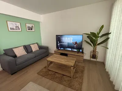 a living room with a television and a couch at Villas Sossego in Porto Santo