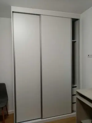 two wardrobes in a kitchen with white walls at Vivenda Silva in Seixal