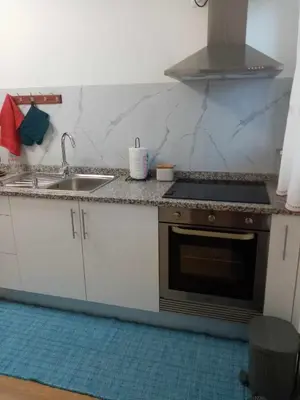 a kitchen with a sink and a stove at Vivenda Silva in Seixal