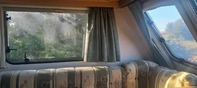 a room with a window and a couch in front at Pauls Mobile Home in Baro de So Joo, Portugal in Barão de São João