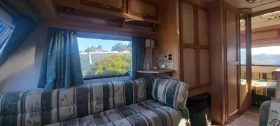 a living room with a couch and a window at Pauls Mobile Home in Baro de So Joo, Portugal in Barão de São João