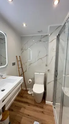 a bathroom with a toilet and a sink and a shower at Sè Urban Suite 21 in Funchal