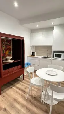 a kitchen with a table and a table and chairs at Sè Urban Suite 21 in Funchal