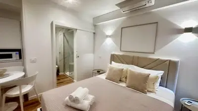 a bedroom with a large white bed with towels on it at Sè Urban Suite 21 in Funchal
