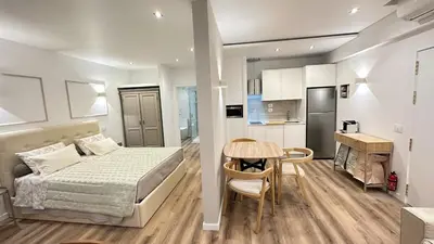 a bedroom with a bed and a table and a kitchen at Se Urban Suite 22 in Funchal