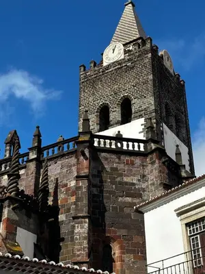 a building with a clock tower on top of it at Se Urban Suite 22 in Funchal