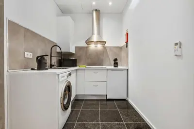 a kitchen with a sink and a washing machine at Funchal Tropical - Filodendro by Homie in Funchal