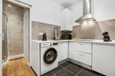 a white kitchen with a washing machine in it at Funchal Tropical - Filodendro by Homie in Funchal