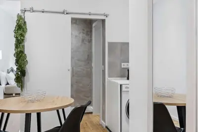 a kitchen and dining room with two tables and chairs at Funchal Tropical - Filodendro by Homie in Funchal