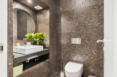 a bathroom with a white toilet and a sink at Funchal Tropical - Filodendro by Homie in Funchal