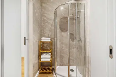 a shower stall in a bathroom with towels at Funchal Tropical - Filodendro by Homie in Funchal