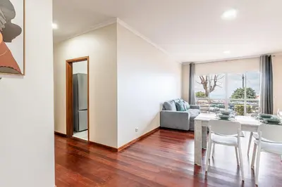 a white bedroom with a large bed and a window at Emerald Scape Garajau Madeira by GRM in Caniço