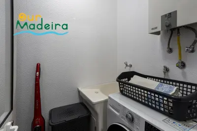a laundry room with a washing machine and a laundry basket at OurMadeira - Alamos UpTown in Funchal