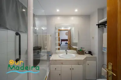 a bathroom with a sink and a mirror at OurMadeira - Alamos UpTown in Funchal