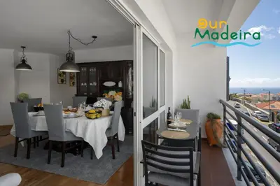 a dining room and kitchen with a table and chairs at OurMadeira - Alamos UpTown in Funchal