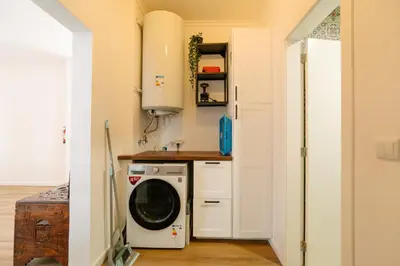a laundry room with a washer and dryer at Sunrise House by Wanderlust Madeira - 2 Bedroom Sea View in Gaula