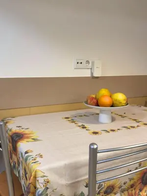 a table with a plate of fruit on top of it at Cantinho da Flor in Relógio do Poiso