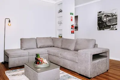 a living room with a gray couch and a table at Dark Yellow in Ponta do Sol
