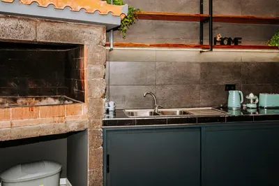 a small kitchen with a sink and a toilet at Dark Yellow in Ponta do Sol