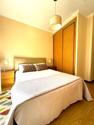 a bedroom with a large white bed in a room at Apartmento Centro Funchal in Funchal