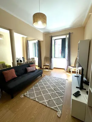 a living room with a couch and a table at Apartmento Centro Funchal in Funchal