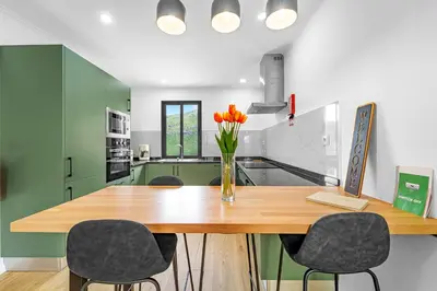 a kitchen with a sink and a view of a mountain at Casa da Guida in Machico