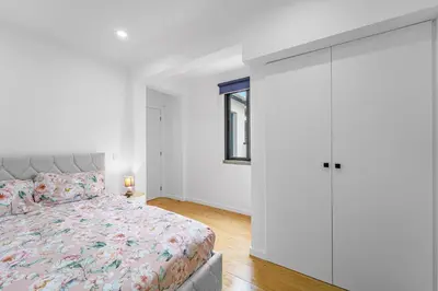 a bedroom with a bed and a tv on a wall at Casa da Guida in Machico