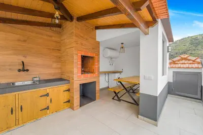 a balcony with two chairs and a staircase at Casa da Guida in Machico