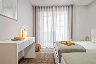 a bedroom with two beds and a dresser and a window at Casa das Raposinhas VI, Funchal in Funchal
