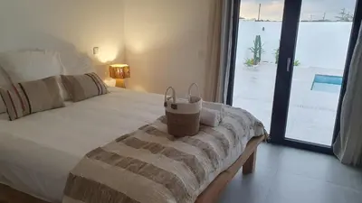 a white bed with two pillows on top of it at villa blue mango in Sagres